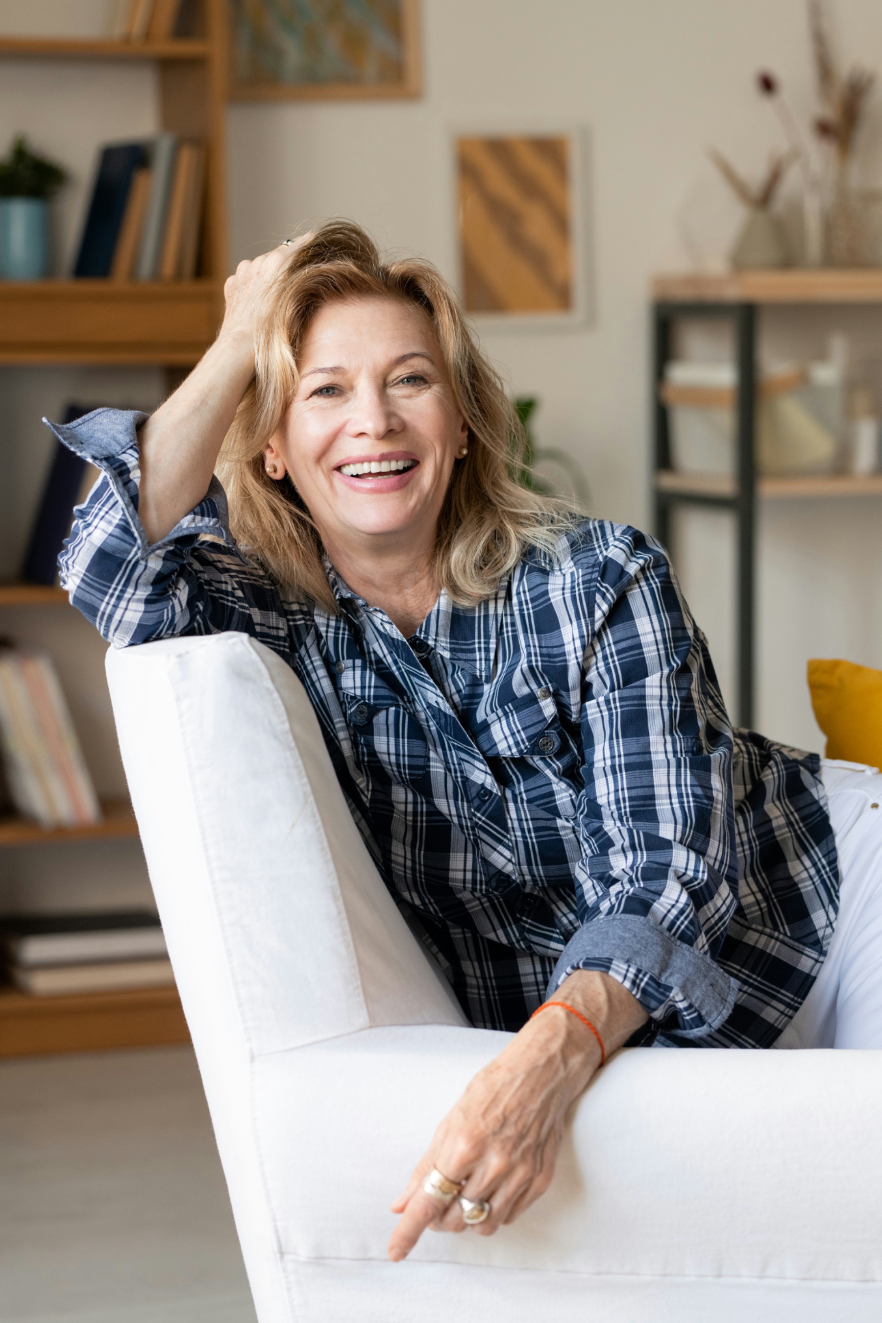 Smiling woman running a hand through her full, natural-looking hair