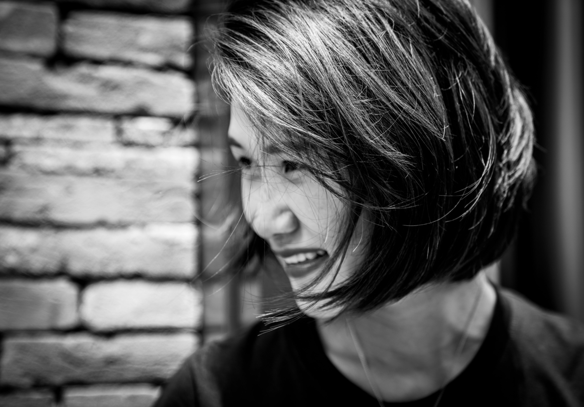 Woman laughing as her full, glossy hair moves